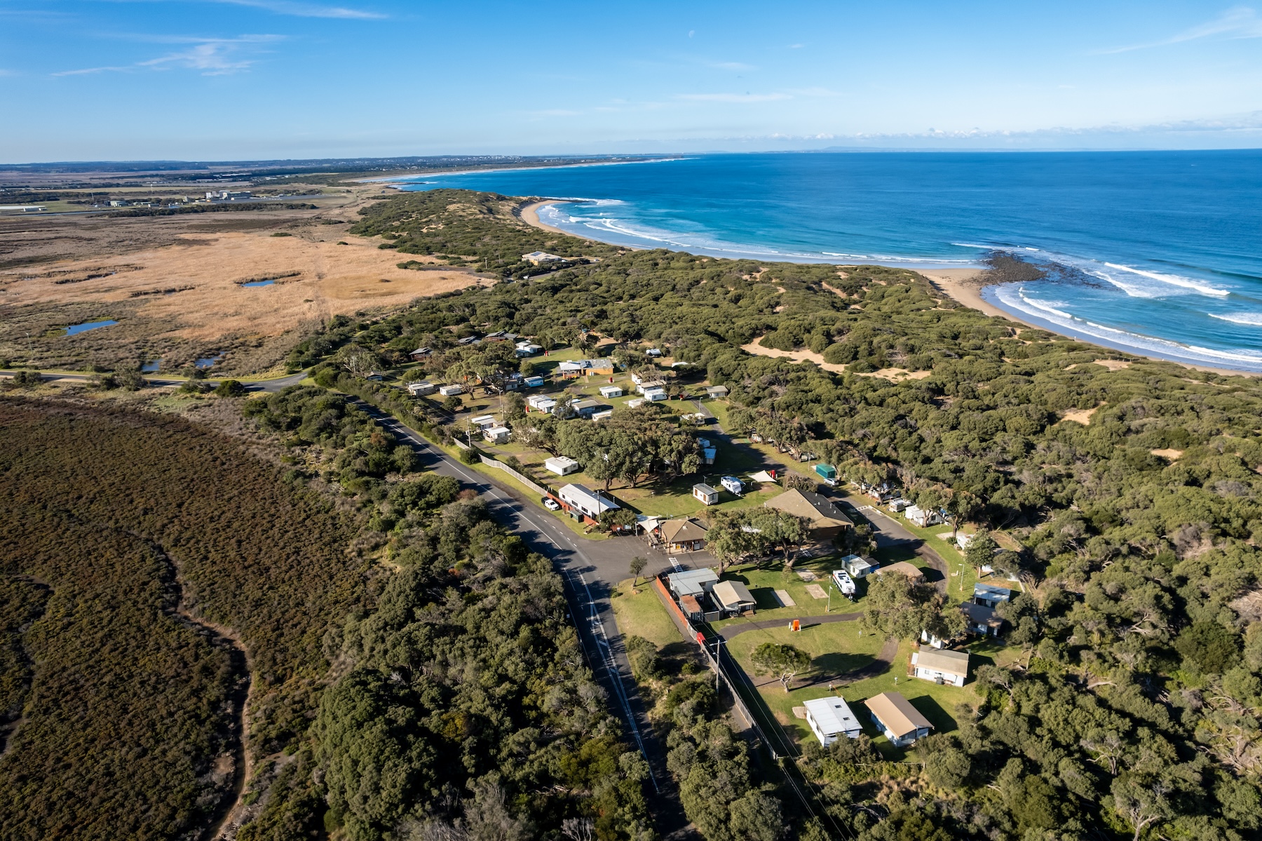 Aerial image of Breamlea Caravan Park shows the wetland, caravan park, dunes and beaches